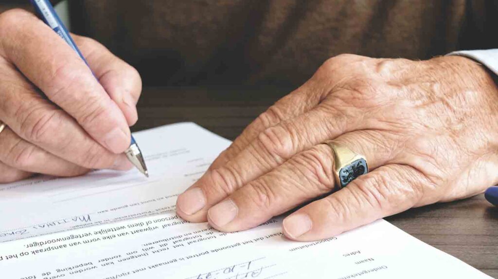 Man filling out real estate documents.